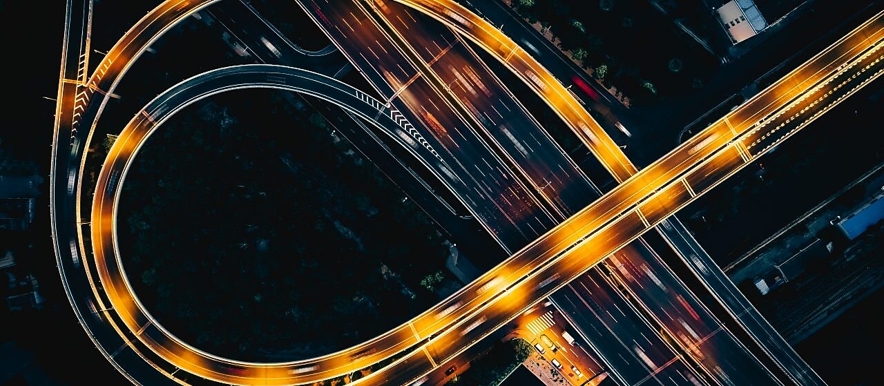 Night highway from above with light streaks