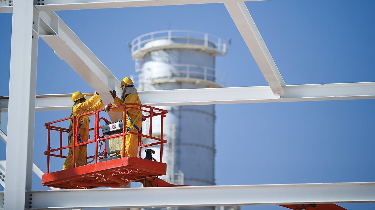 Two engineers on crane doing maintenance work