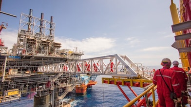 Ouvriers traversant une nouvelle plate-forme de compression sur le projet en eau profonde de Malampaya