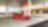 Une Ferrari rouge arrêtée à la pompe d'une station Shell avec un homme qui s'apprête à faire le plein